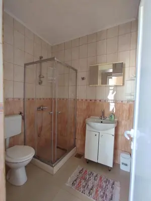 a bathroom with a shower and a toilet and a sink at Apartmani Andrijana in Ulcinj