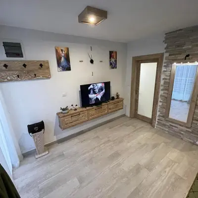 a living room with a flat screen tv on a wall at Apartman Anna Budva in Budva