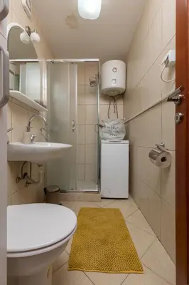 a bathroom with a sink and a toilet and a shower at Apartment Amigo 2 Old Town Kotor in Kotor