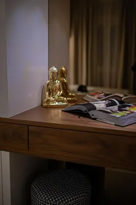 a desk with a gold statue on top of it at Enyana Luxury Suites in Kotor
