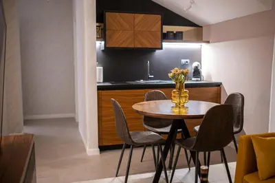 a kitchen with a table and chairs in a room at Enyana Luxury Suites in Kotor