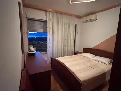 a hotel room with a bed and a window at PA Max apartment in Kotor