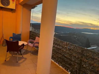 a balcony with a table and chairs and a view at PA Max apartment in Kotor