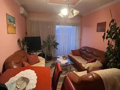 a living room with leather couches and a television at PA Max apartment in Kotor