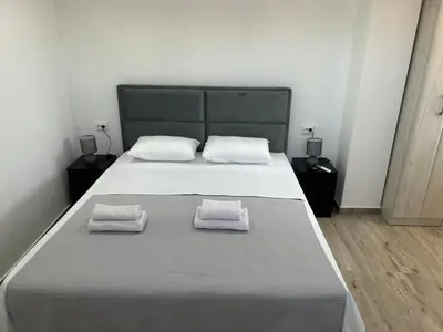 a bedroom with a large bed with two towels on it at Apartment Filipovic in Podgorica