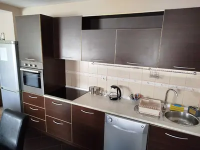 a kitchen with wooden cabinets and a sink at Apartment Filipovic in Podgorica