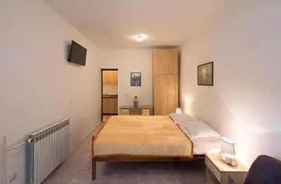 a bedroom with a large bed in a room at Madra Rooms and Apartments in Budva
