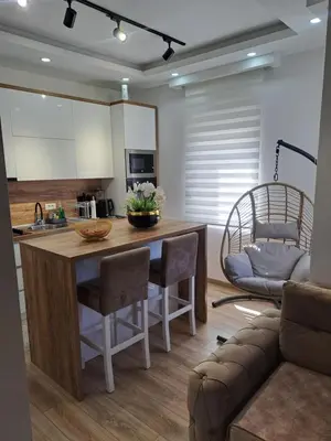 a kitchen with a island with chairs and a couch at Long beach luxury Premium apartments in Ulcinj