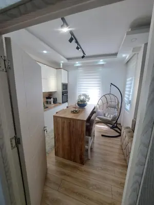 a kitchen and dining room with a wooden table and a dining room at Long beach luxury Premium apartments in Ulcinj