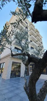 a building with a tree in front of it at Apartment Verde in Bar