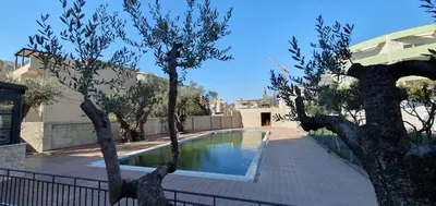 a swimming pool with trees in front of a house at Apartment Verde in Bar