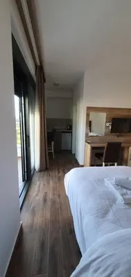 a bedroom with a white bed and a desk with a desk at Apartment Verde in Bar