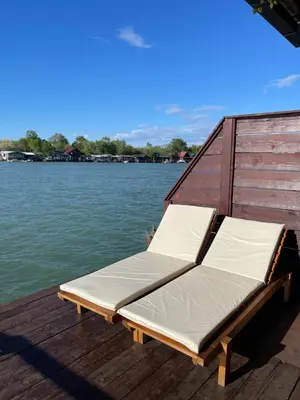 a bed on the back of a boat on the water at River house Velero in Ulcinj