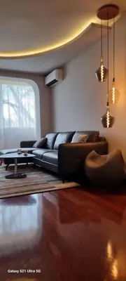 a living room with a couch and a table at Rosewood Podgorica in Podgorica