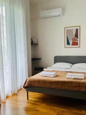 a bedroom with a bed with two towels on it at Cozy studio Bečići in Becici