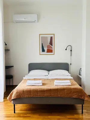 a bedroom with a bed with two towels on it at Cozy studio Bečići in Becici