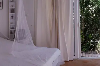 a white bedroom with a bed with a veil at Luxury place with a magnificent view in Budva