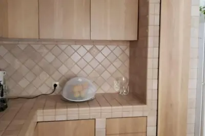a kitchen counter with a bowl and two glasses on it at Luxury place with a magnificent view in Budva