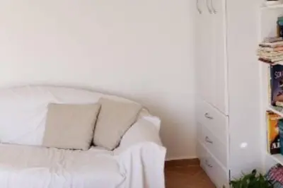 a white couch with two pillows in a room at Luxury place with a magnificent view in Budva