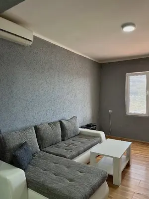 a living room with a couch and a table at Old Town Bar Apartments in Stari Bar