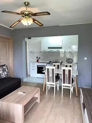 a living room with a table and a kitchen at Old Town Bar Apartments in Stari Bar