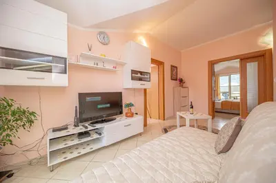 a bedroom with a bed and a tv in a room at Fairytale 1 and 2 in Budva