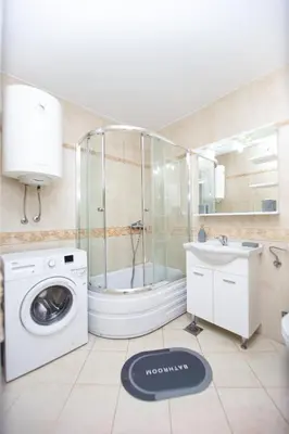 a bathroom with a washing machine and a sink at Fairytale 1 and 2 in Budva