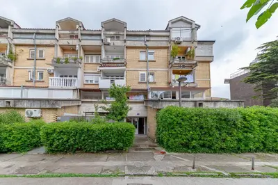 an apartment building with bushes in front of it at Fairytale 1 and 2 in Budva