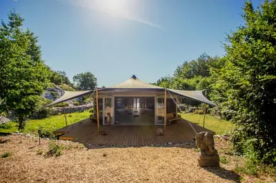 a yurt with a wooden deck in a field at Ashuma Retreat in Cetinje