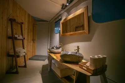 a bathroom with two sinks on a wooden counter at Ashuma Retreat in Cetinje