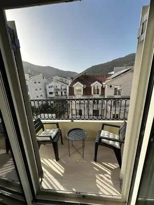 a balcony with chairs and a view of a city at Saly Apart in Budva