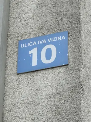 a blue sign on the side of a building at Selena apartment in Podgorica
