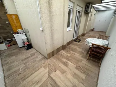 a hallway with a table and chairs in a building at Selena apartment in Podgorica