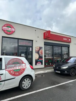 two cars parked in front of a fast food restaurant at Selena apartment in Podgorica
