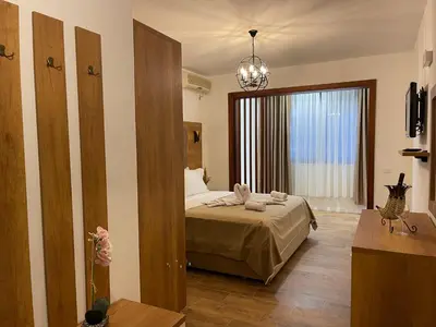 a bedroom with a bed and a large window at Apartments Miri in Ulcinj