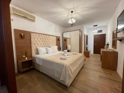 a bedroom with a large bed and a large mirror at Apartments Miri in Ulcinj
