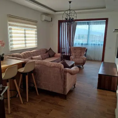 a living room with a couch and a table and chairs at Apartments Miri in Ulcinj
