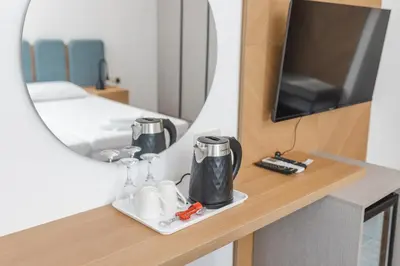 a room with a mirror and a coffee maker on a table at Apartments Mara Lux in Budva