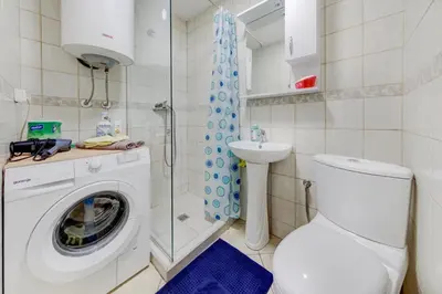 a bathroom with a washing machine and a sink at Apartment Makao in Podgorica