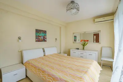 a bedroom with a bed and a dresser and a mirror at Golden bay in Bar