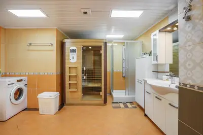 a bathroom with a washing machine and a washer at Golden bay in Bar