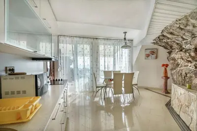 a kitchen and dining room with a table and chairs at Golden bay in Bar