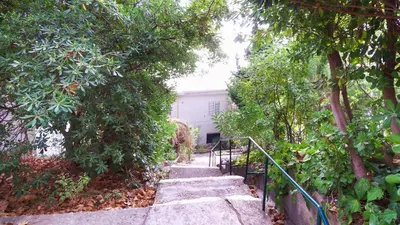 a set of stairs leading up to a house with trees at Golden bay in Bar