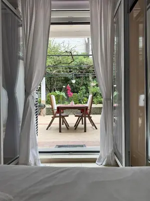 a room with a window with a table and chairs at Splendid Luxury Apartments in Budva