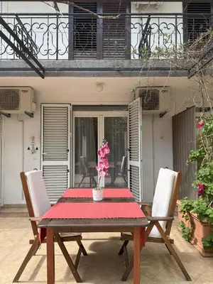 a wooden table with a vase of flowers on it at Splendid Luxury Apartments in Budva