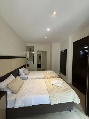a bedroom with two beds with white sheets at Splendid Luxury Apartments in Budva