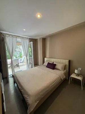 a bedroom with a large bed and a balcony at Splendid Luxury Apartments in Budva