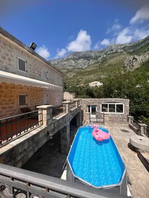 a house with a swimming pool on a balcony at Vila Reževići in Budva
