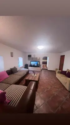 a living room with couches and a flat screen tv at Vila Reževići in Budva