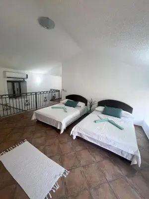two beds sitting next to each other in a room at Vila Reževići in Budva